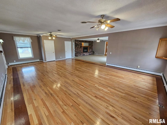 unfurnished living room featuring ornamental molding and baseboard heating