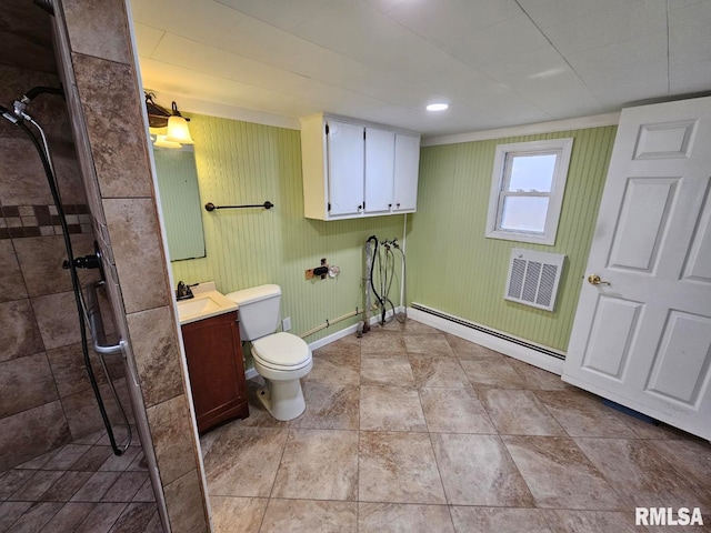 bathroom featuring vanity, tiled shower, toilet, and baseboard heating