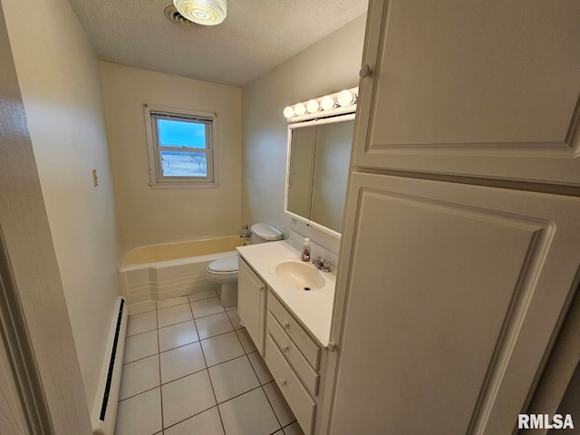 bathroom featuring tile patterned flooring, vanity, a baseboard heating unit, toilet, and a textured ceiling