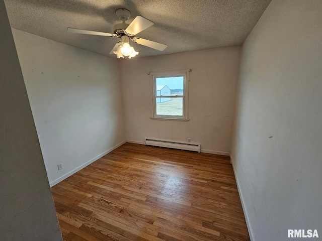 unfurnished room with hardwood / wood-style flooring, a baseboard radiator, ceiling fan, and a textured ceiling