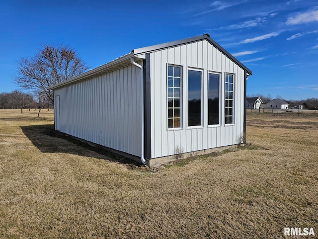 view of outbuilding with a yard