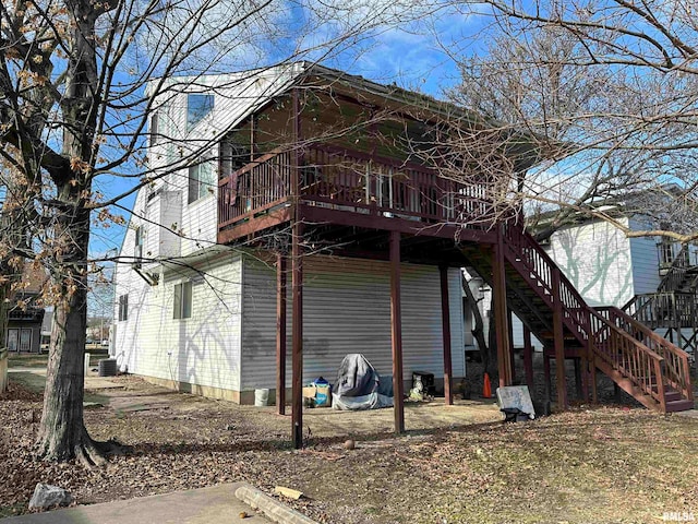 back of house featuring a wooden deck