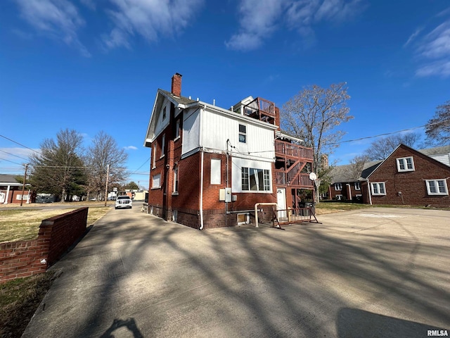 back of house featuring a wooden deck