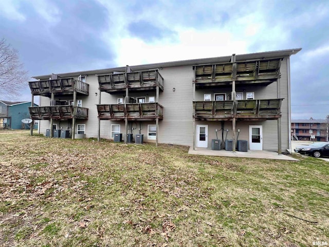 back of house with a yard, a patio, and central air condition unit