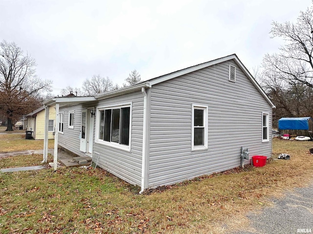 view of property exterior with a lawn