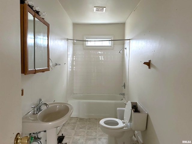 full bathroom with sink, tile floors, toilet, and tiled shower / bath