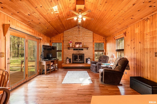 living room with wooden ceiling, a fireplace, wood-type flooring, and wood walls