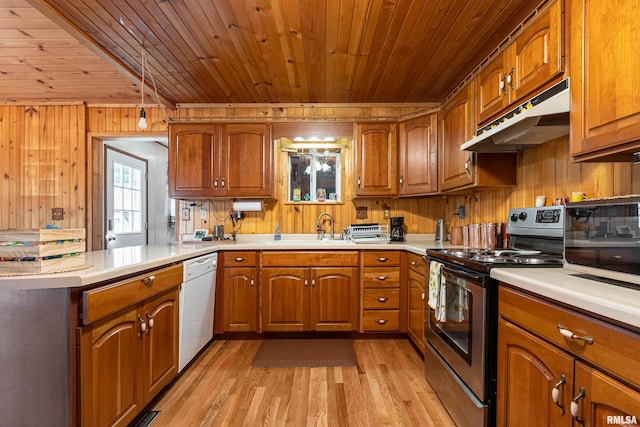 kitchen with wooden walls, wooden ceiling, light wood-type flooring, stainless steel appliances, and sink