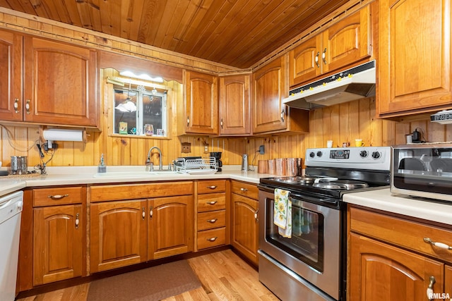 kitchen with wood walls, light hardwood / wood-style flooring, wood ceiling, electric range, and sink