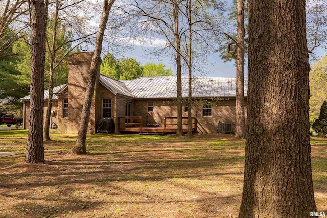 view of yard with central AC and a wooden deck