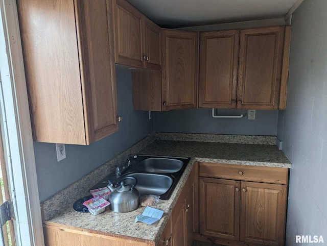 kitchen with sink and light stone counters