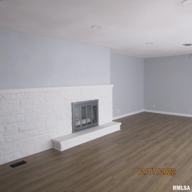 unfurnished living room featuring dark hardwood / wood-style floors