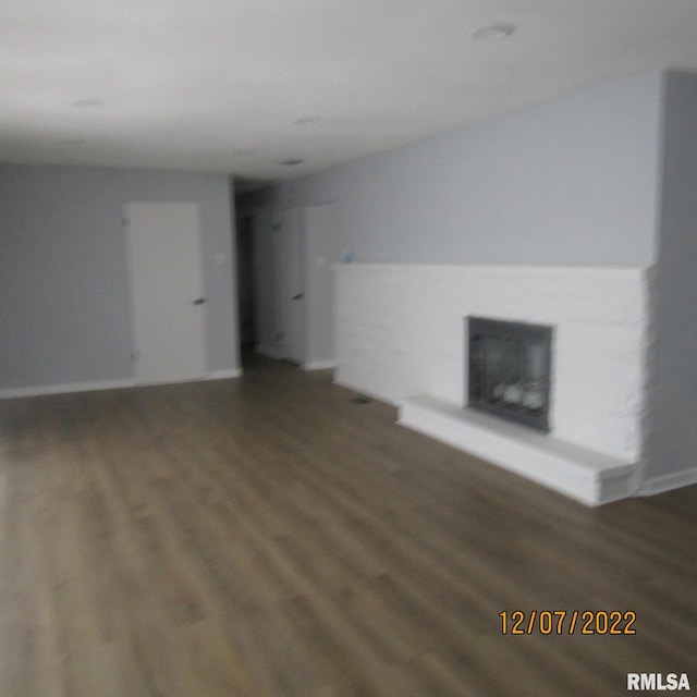 unfurnished living room with dark hardwood / wood-style flooring