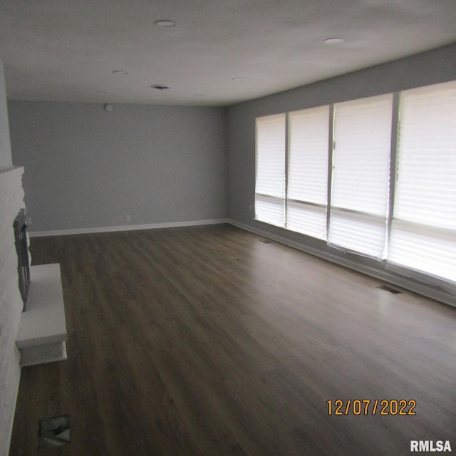 unfurnished living room featuring dark wood-type flooring