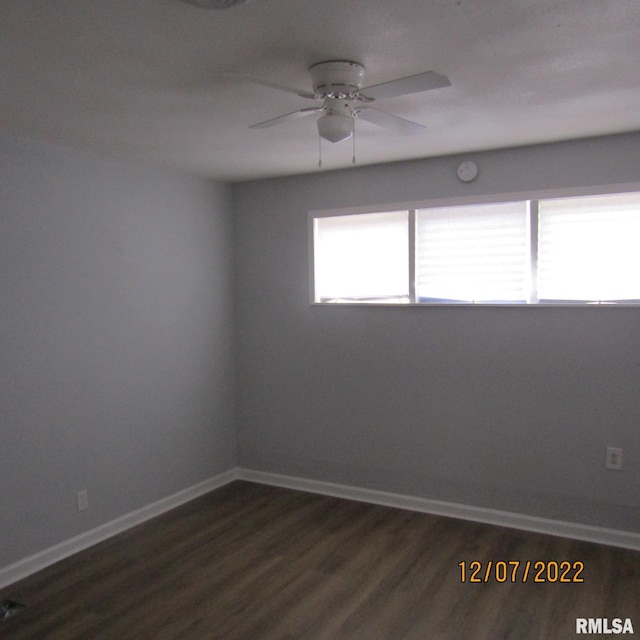 spare room with ceiling fan and dark hardwood / wood-style flooring