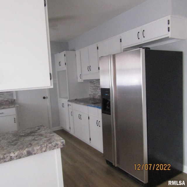 kitchen with stainless steel fridge with ice dispenser, backsplash, white cabinets, and dark wood-type flooring