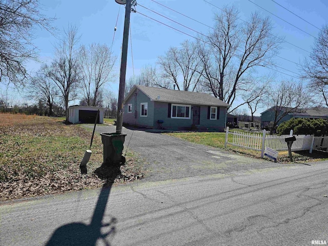 single story home featuring a front lawn and a garage