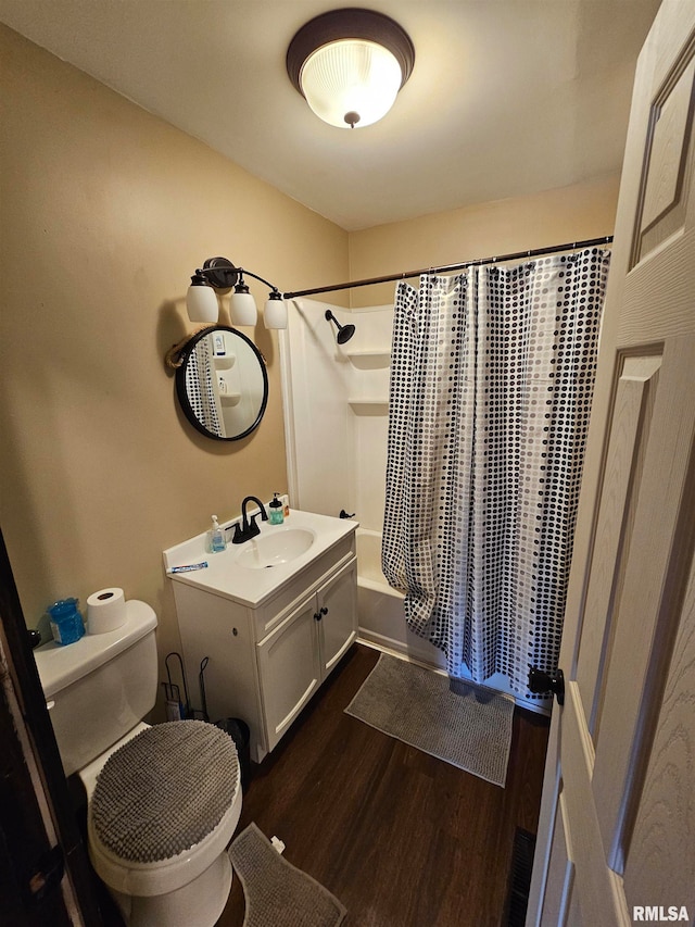 full bathroom with shower / bath combo with shower curtain, large vanity, toilet, and hardwood / wood-style flooring