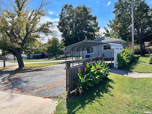 view of front of house with a front yard and a carport