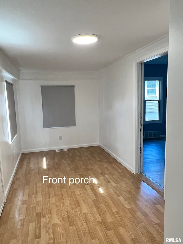 empty room with light hardwood / wood-style flooring