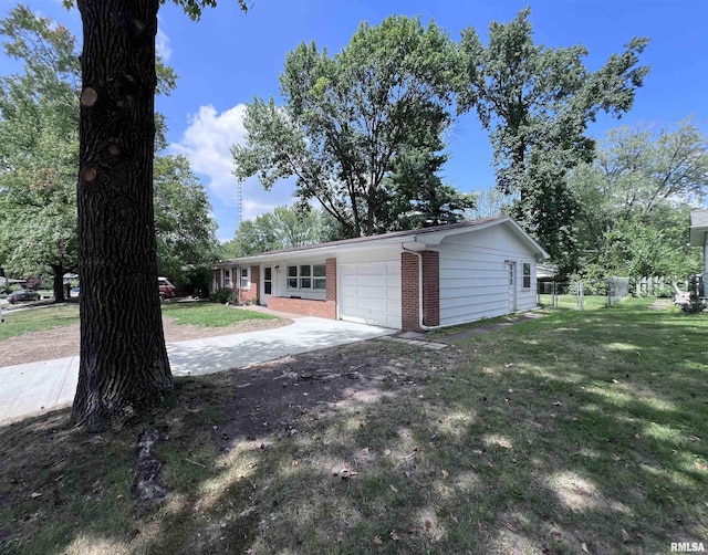 garage featuring driveway and fence