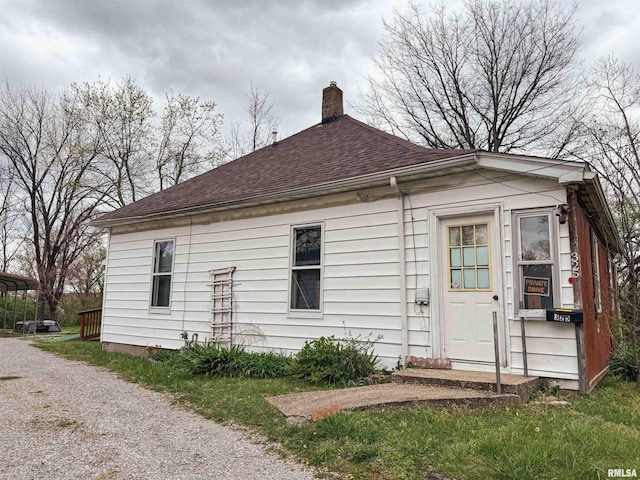 back of property with a carport