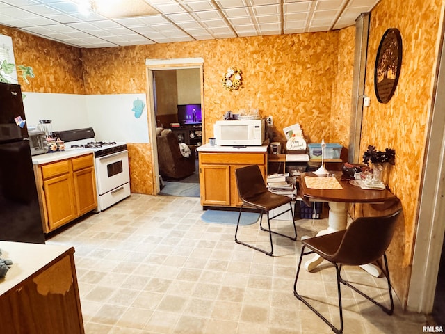 kitchen with white appliances, brown cabinets, and light countertops