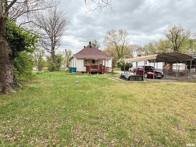 view of yard featuring a detached carport and a deck