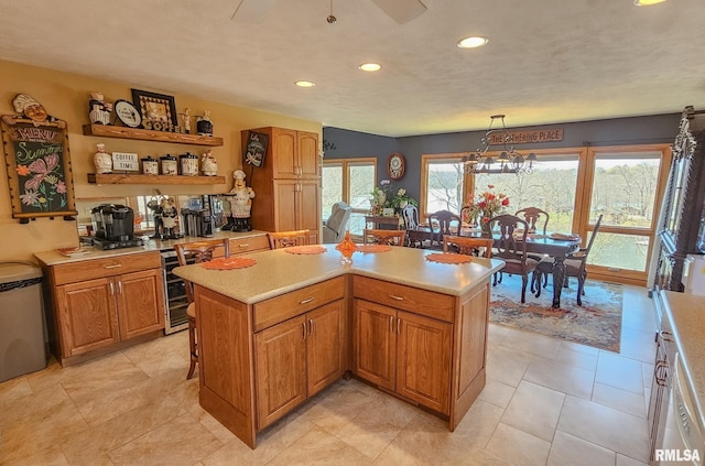 kitchen featuring light tile flooring, an inviting chandelier, beverage cooler, and plenty of natural light