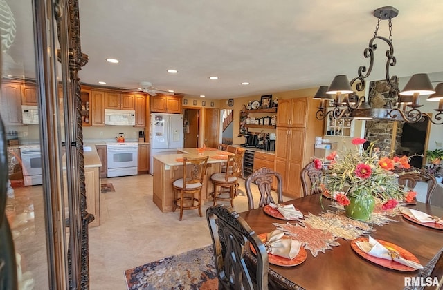 tiled dining room with beverage cooler, ceiling fan, and a fireplace