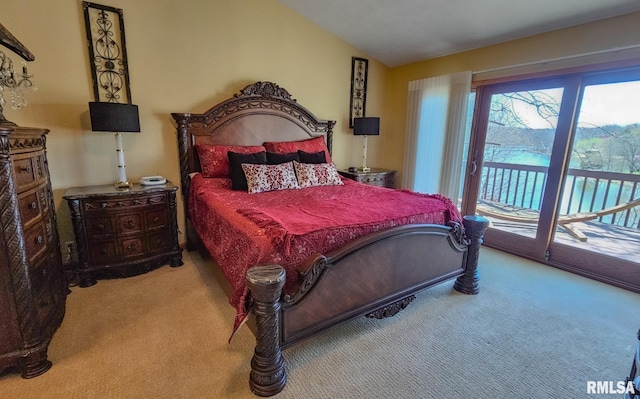 bedroom with lofted ceiling, access to outside, light carpet, and multiple windows