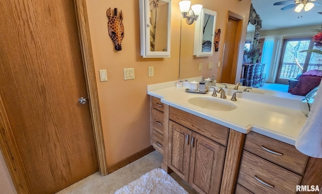 bathroom featuring ceiling fan, vanity, and tile floors