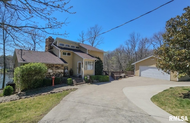 view of front of property with an outdoor structure and a garage