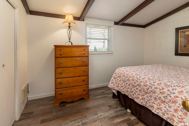 bedroom featuring beamed ceiling, dark hardwood / wood-style floors, and a closet