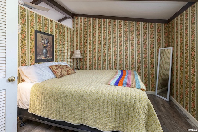 bedroom with lofted ceiling with beams and dark hardwood / wood-style floors