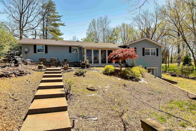 back of house featuring a sunroom and a patio area