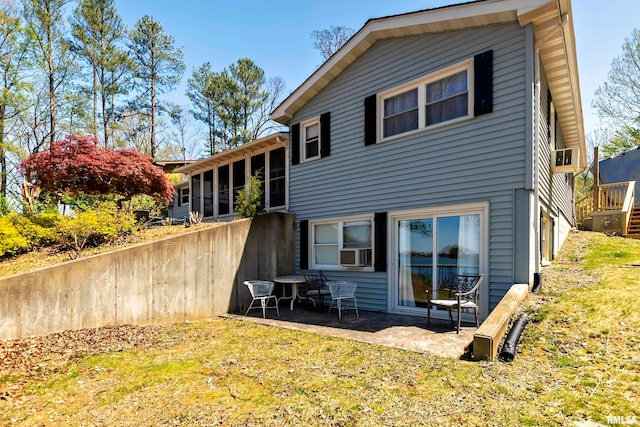 rear view of property featuring cooling unit, a yard, and a patio