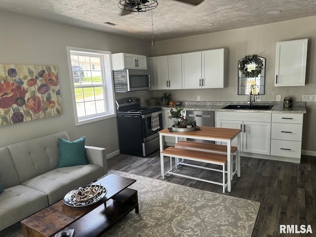 kitchen with ceiling fan, white cabinetry, sink, and black / electric stove