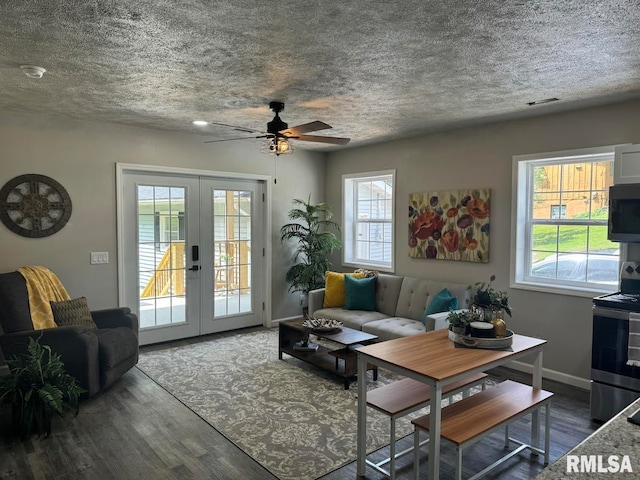 living room with ceiling fan, dark wood-type flooring, and french doors