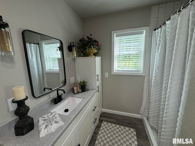 bathroom featuring a shower with shower curtain, vanity, and wood-type flooring