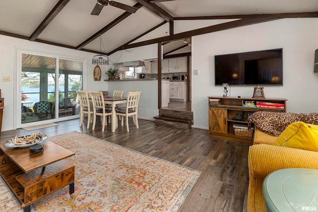 living room with vaulted ceiling with beams, ceiling fan, and dark wood-type flooring