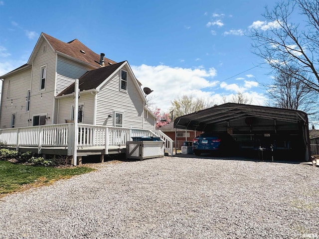 view of property exterior featuring a deck and a carport