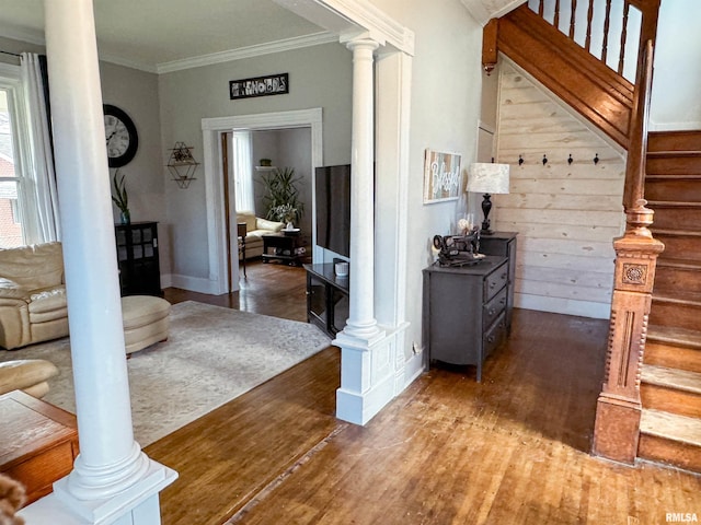 interior space featuring wood-type flooring and ornamental molding