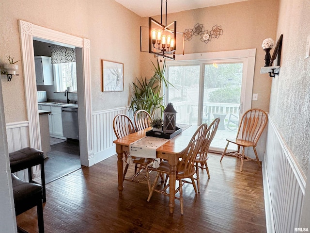 dining room featuring a notable chandelier, dark hardwood / wood-style floors, and sink