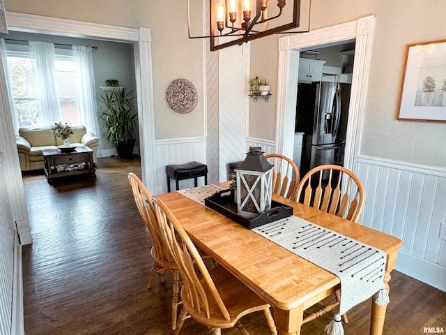 dining area featuring an inviting chandelier and dark wood-type flooring