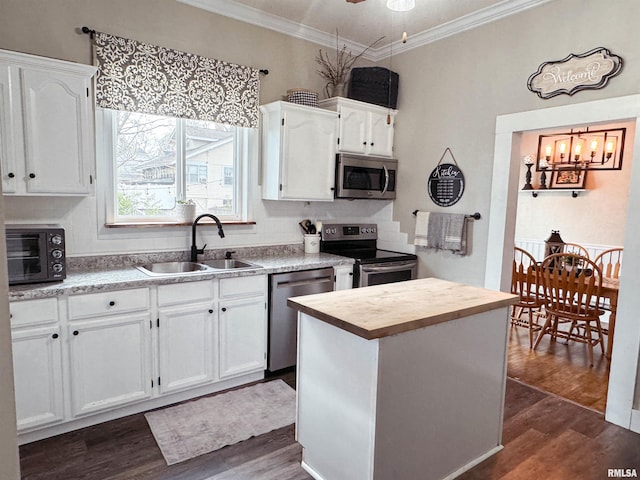 kitchen featuring stainless steel appliances, dark wood-type flooring, sink, and white cabinetry