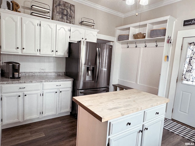 kitchen featuring decorative backsplash, a center island, white cabinets, dark hardwood / wood-style flooring, and ornamental molding