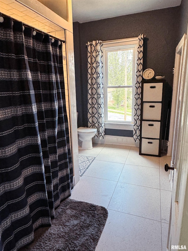 bathroom featuring tile patterned floors and toilet