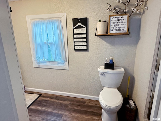 bathroom featuring toilet and wood-type flooring