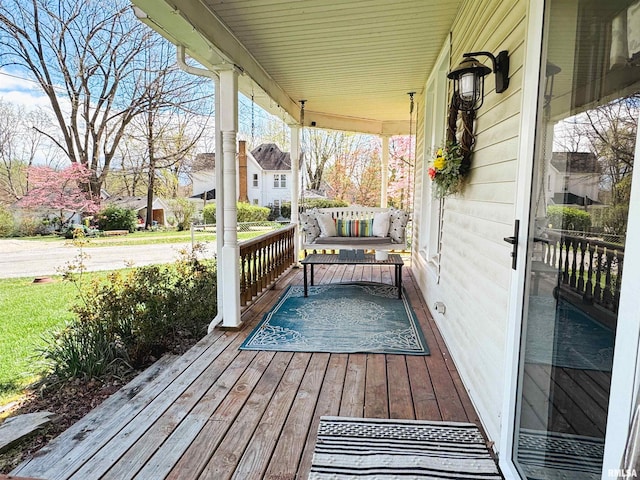 wooden terrace featuring covered porch